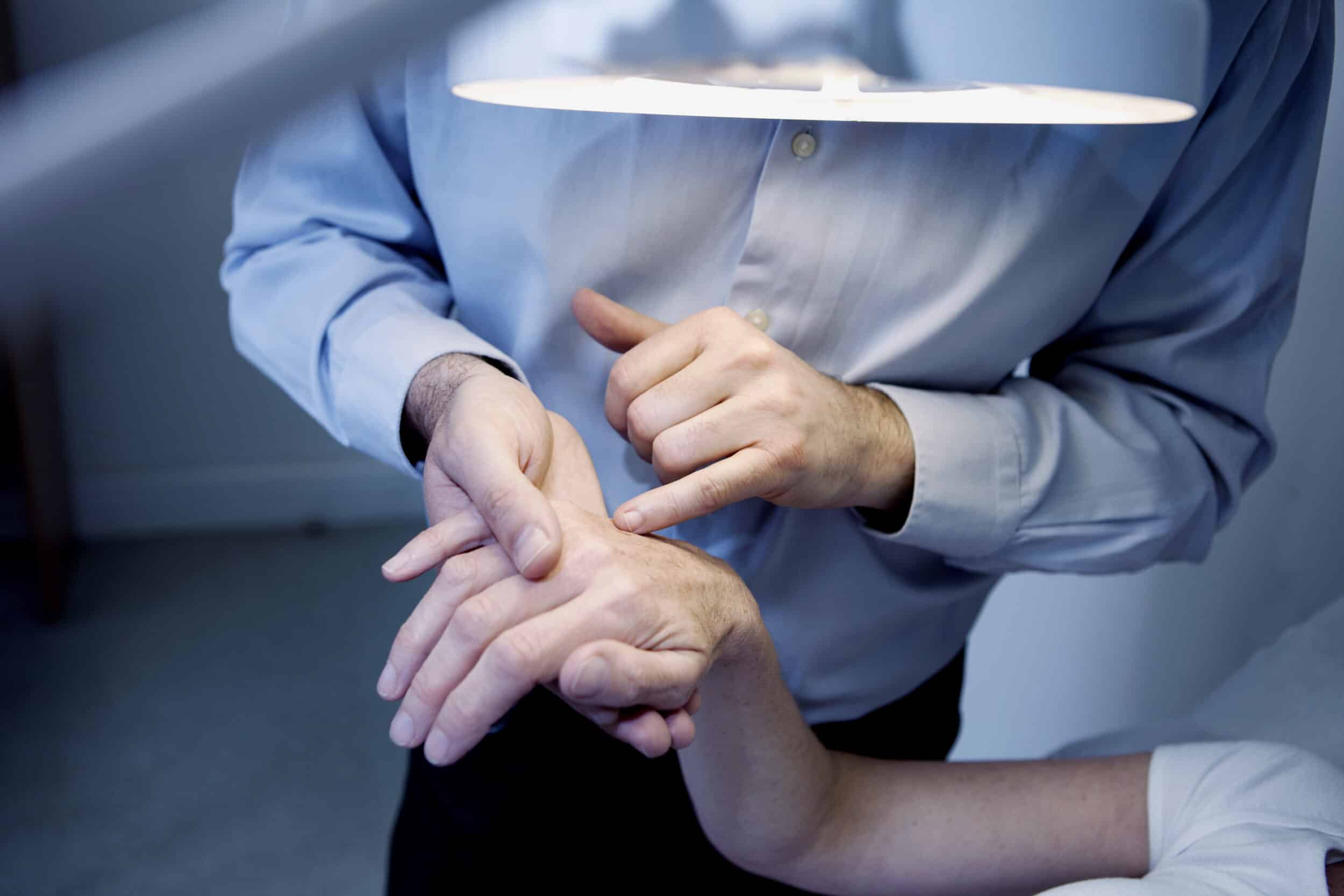 A dermatologist examining a patient for squamous cell carcinoma